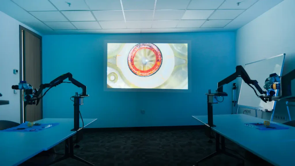 Ophthalmology wet-lab training room with surgical microscopes and retinal projection used for simulation training