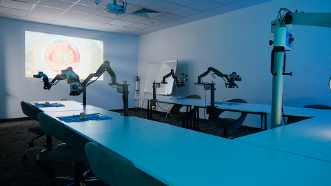 Ophthalmology wet-lab training room with multiple surgical workstations and retinal projection used for simulation training