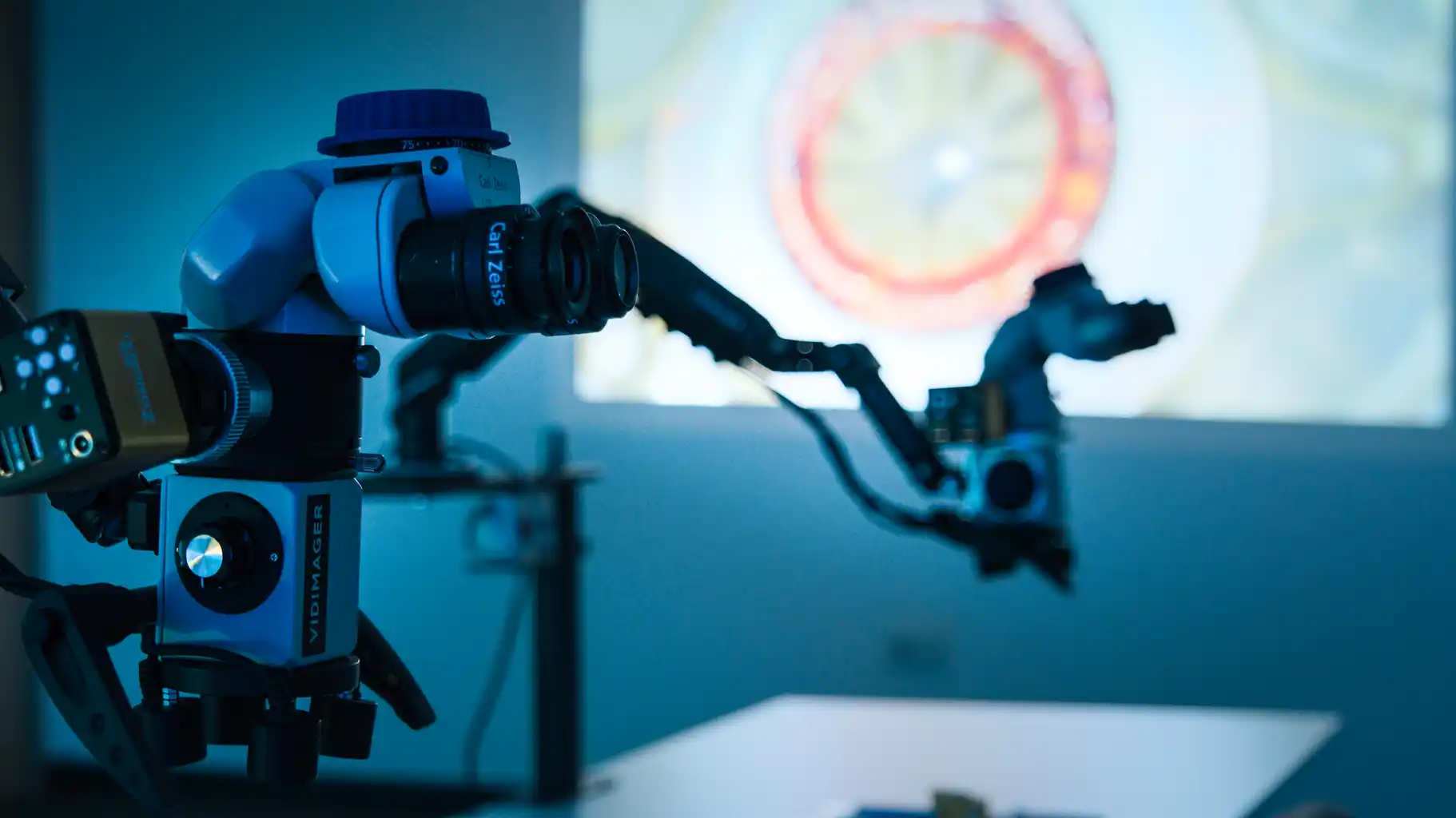 Close-up view of an ophthalmic surgical microscope used in wet-lab simulation training