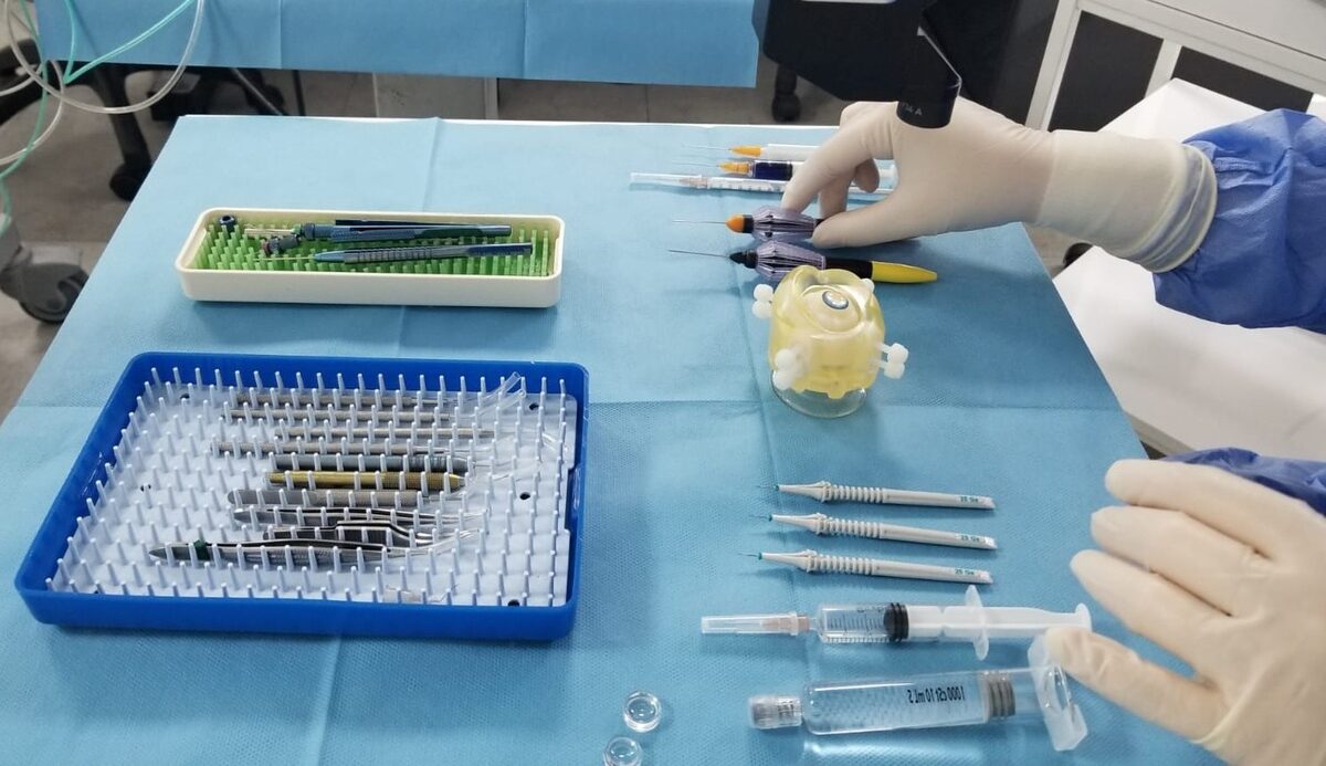 Microsurgical instruments and an artificial eye model prepared for structured wet-lab practice.
