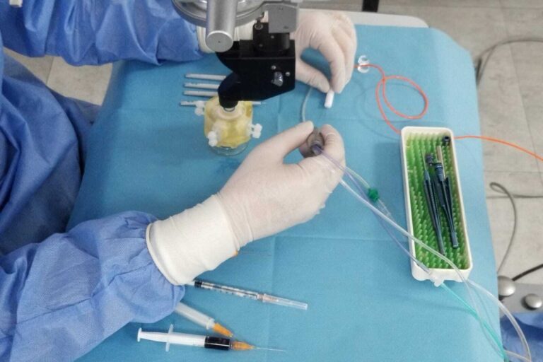 Gloved hands practicing on an artificial eye model under simulation conditions — OphthalmoClub
